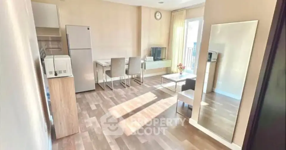 Bright and spacious living room with modern furniture and large mirror, perfect for entertaining.