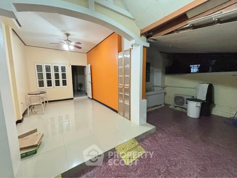 Spacious interior with unique architectural features and vibrant accent wall