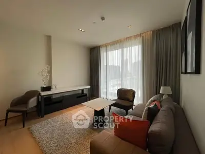 Modern living room with stylish furniture and large window view.