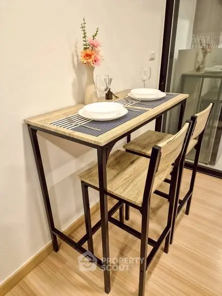 Chic dining nook with modern high table and chairs, perfect for cozy meals in compact spaces.