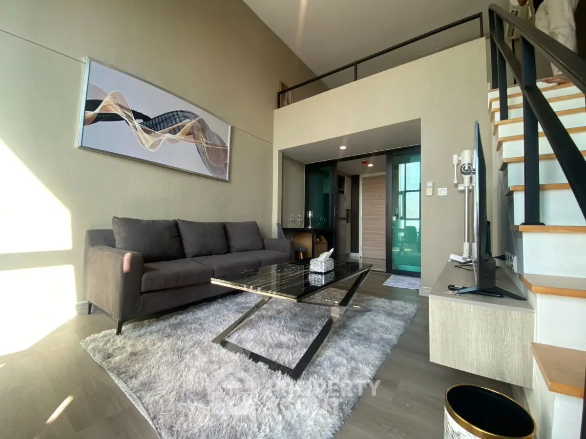 Modern loft-style living room with high ceiling and stylish decor