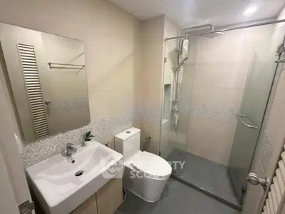 Modern bathroom with sleek shower and stylish fixtures in a contemporary apartment.