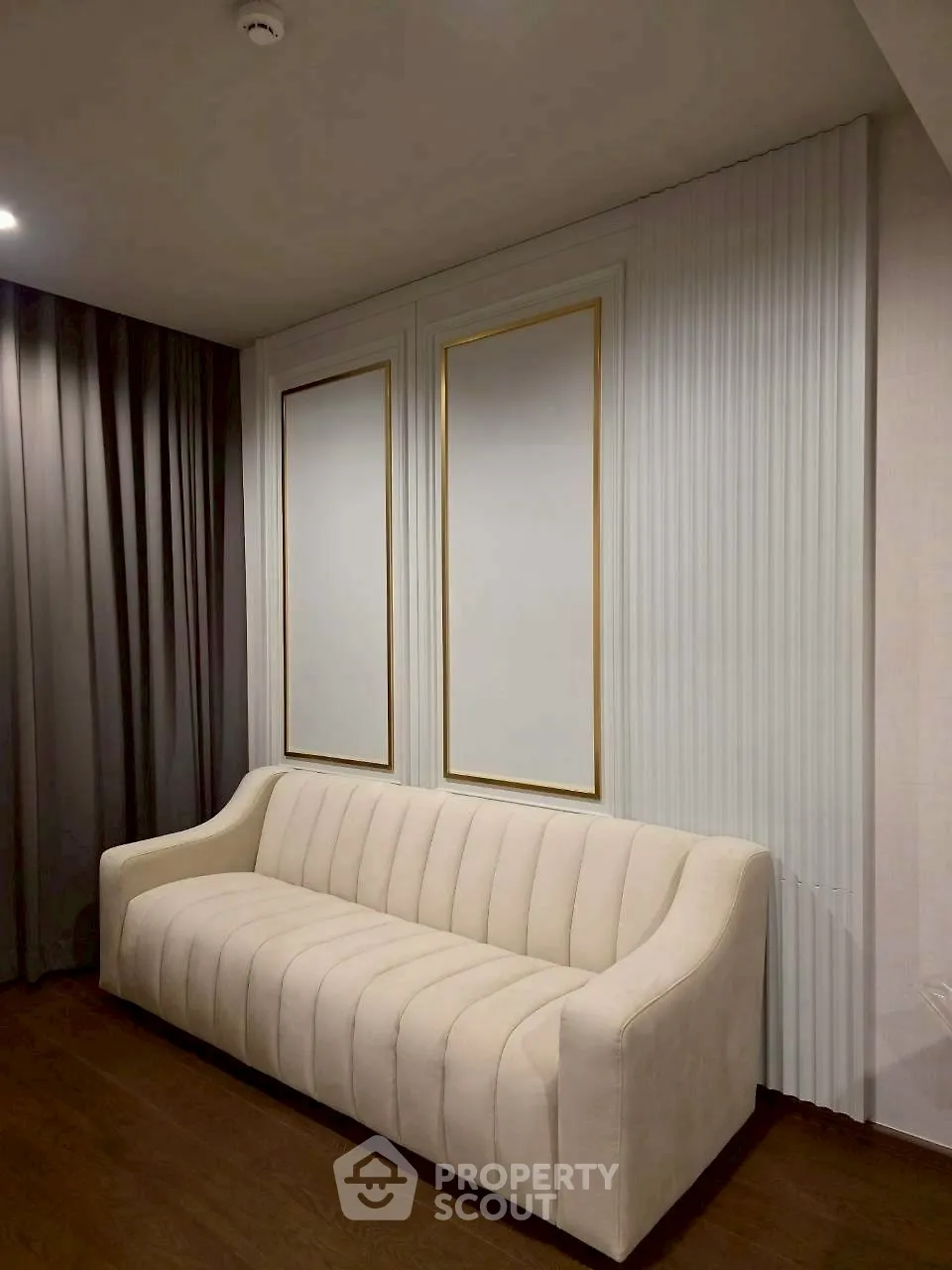 Elegant living room with modern white sofa and stylish wall decor