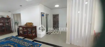 Spacious living area with elegant decor and unique wall art