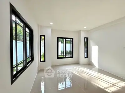 Bright and airy empty room with large windows and glossy tiled floor