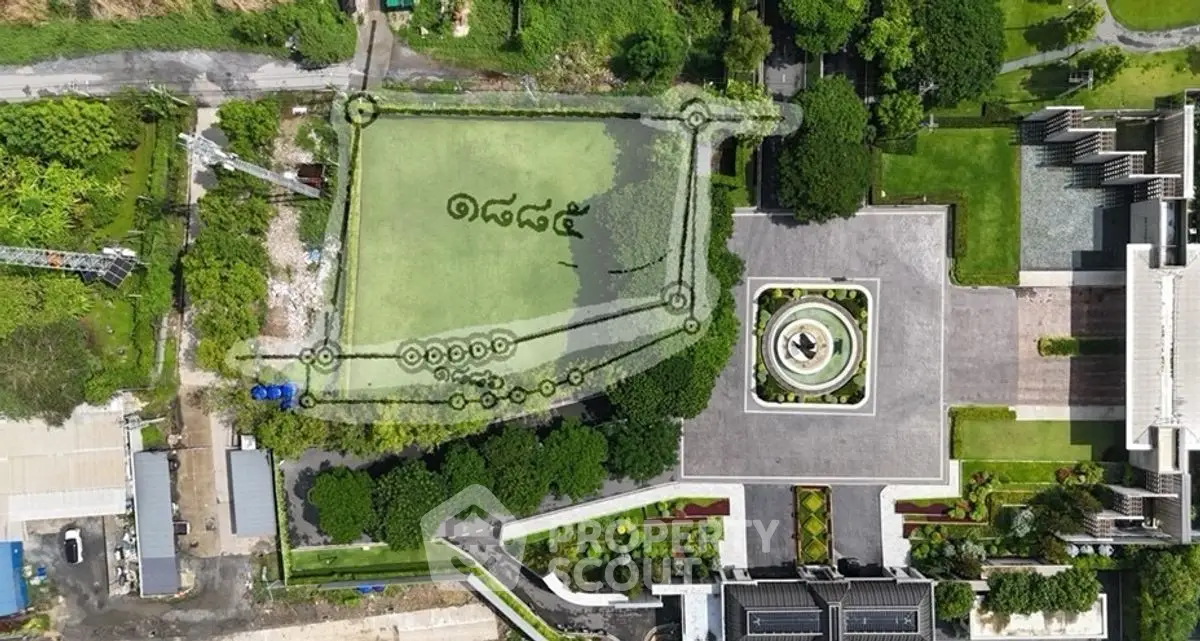 Aerial view of a landscaped garden with a central fountain and surrounding greenery.