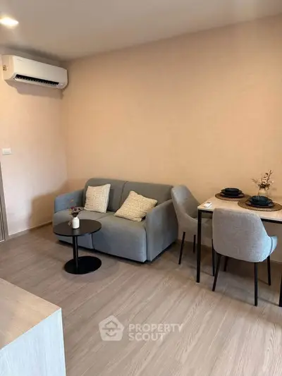 Modern living room with cozy sofa and dining area in stylish apartment.