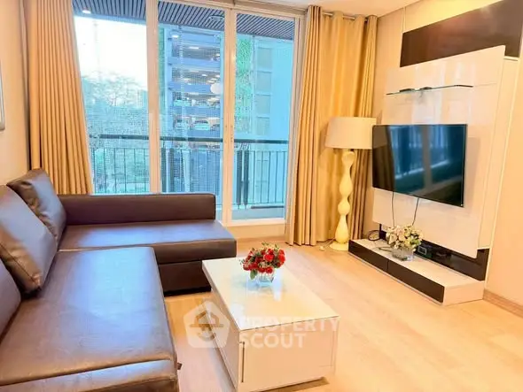 Modern living room with large window and stylish furniture in urban apartment.