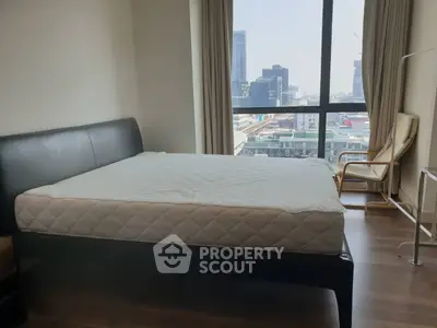 Spacious bedroom with city view and modern furnishings