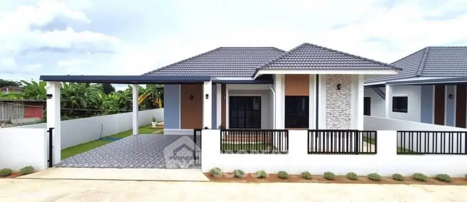 Modern single-story house with tiled roof and spacious driveway