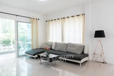 Spacious modern living room with large windows and stylish decor