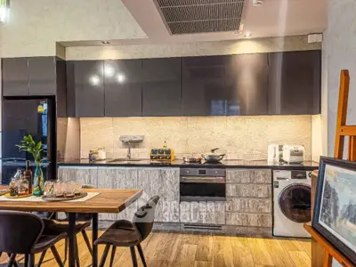 Modern kitchen with sleek cabinets, integrated appliances, and stylish dining area.