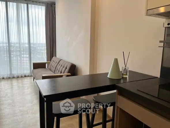 Modern apartment interior with stylish furniture and panoramic window view.