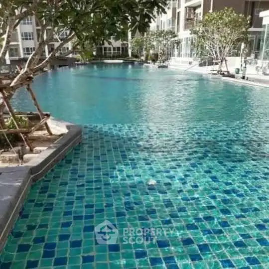 Luxurious residential pool area with crystal-clear water and lush surroundings.