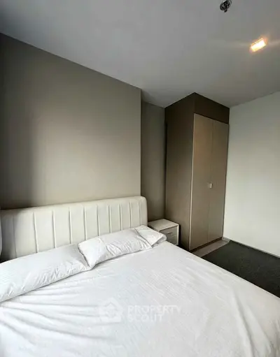 Modern bedroom with sleek design and built-in wardrobe, perfect for urban living.