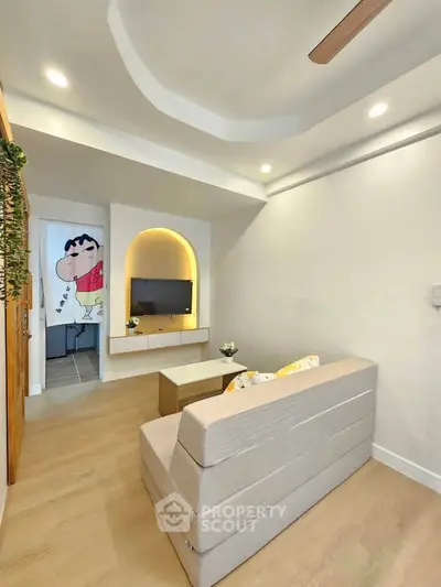 Modern living room with stylish ceiling design and cozy seating area, perfect for relaxation.