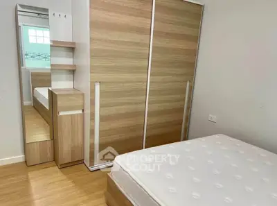 Modern bedroom with sleek wooden wardrobe and comfortable mattress, perfect for a cozy living space.