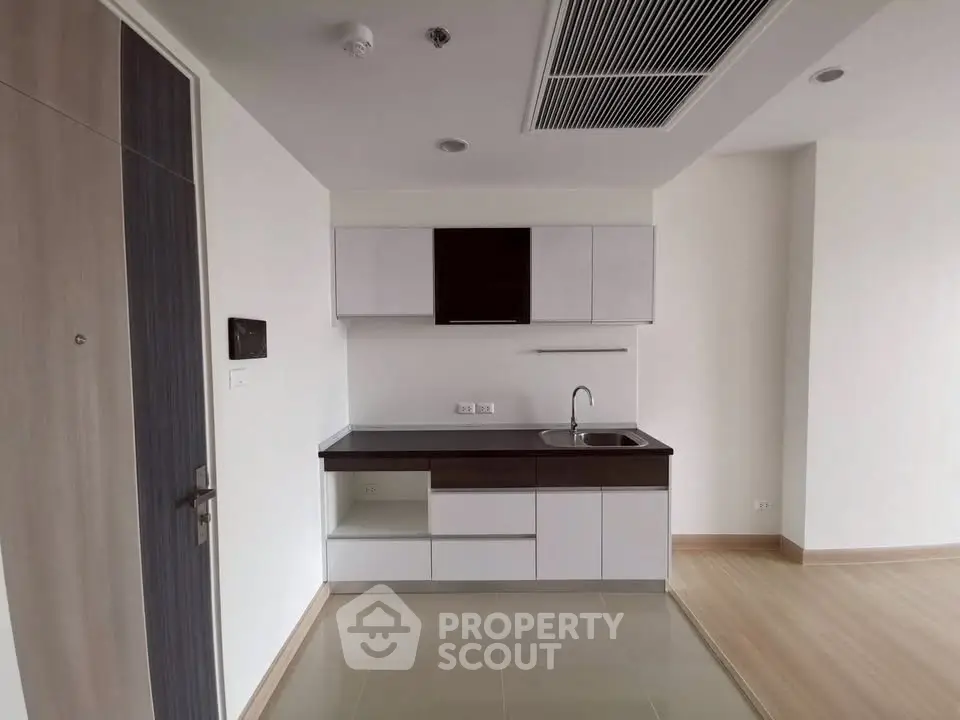 Modern minimalist kitchen with sleek cabinetry and compact design