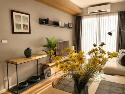 Stylish living room with modern decor, large window, and cozy seating area.