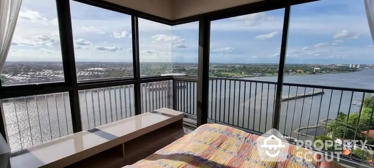 Stunning bedroom with panoramic waterfront view from high-rise apartment