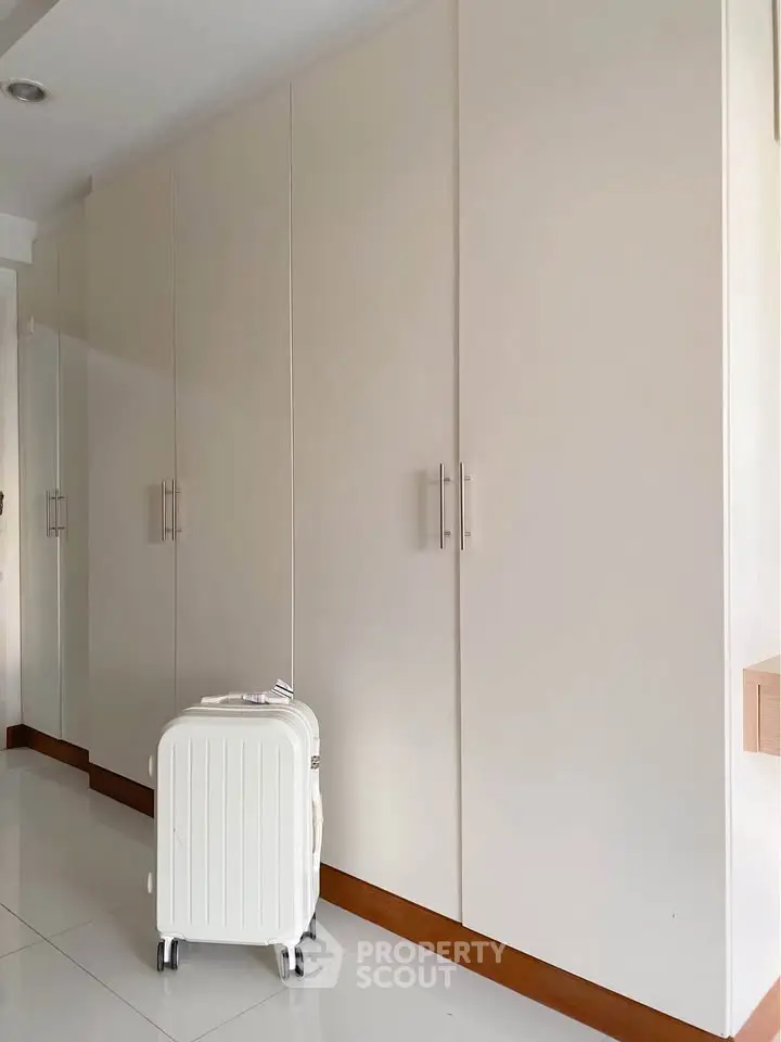 Spacious storage area with sleek white cabinets and modern design