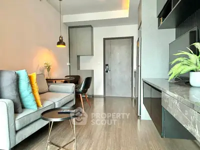 Modern living room with stylish decor and open layout, featuring a cozy sofa and elegant dining area.