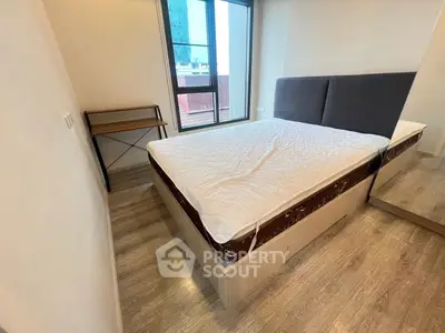 Cozy bedroom with large window and modern furnishings