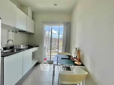 Modern kitchen with sleek cabinets and balcony view, perfect for urban living.