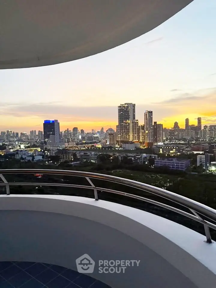 Stunning city skyline view from a spacious balcony at sunset, perfect for urban living enthusiasts.