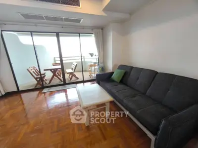 Spacious living room with balcony access and stylish wooden flooring