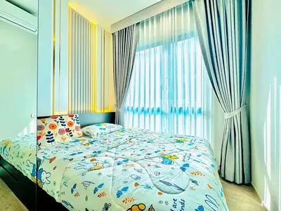 Bright and cozy bedroom with large window and stylish curtains