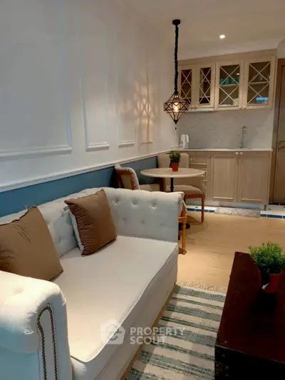 Charming living room with cozy seating and elegant kitchen area, perfect for modern living.