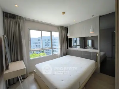 Bright and modern bedroom with large window and stylish decor in a contemporary apartment.
