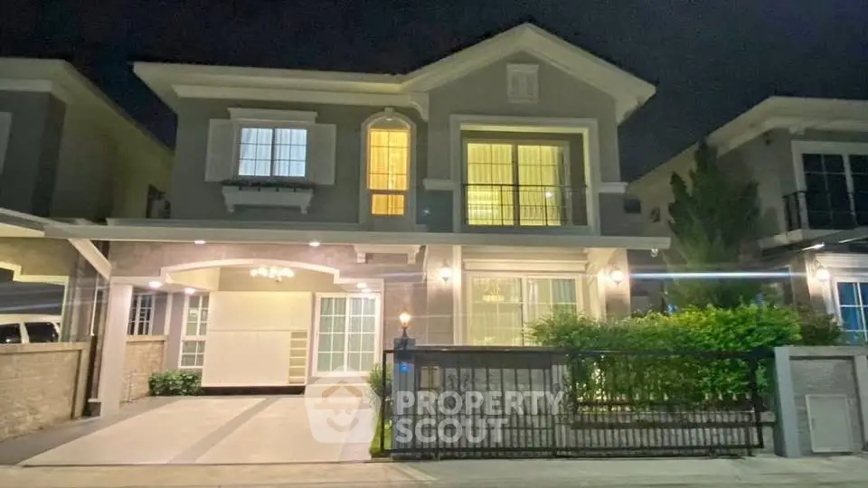 Elegant two-story house with modern facade and warm lighting at night