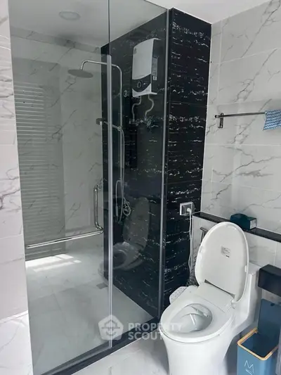 Modern bathroom with glass shower and sleek toilet design