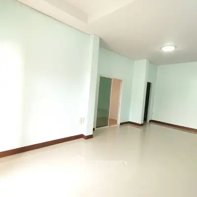 Spacious empty room with light walls and glossy floor, perfect for customization.