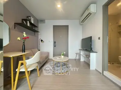 Modern living room with cozy seating, stylish decor, and a compact dining area.