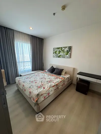 Cozy bedroom with floral bedding and modern decor in a bright apartment