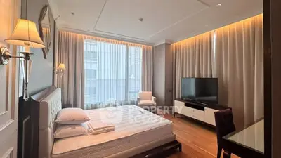 Luxurious bedroom with modern decor, large windows, and elegant lighting in a high-end apartment.