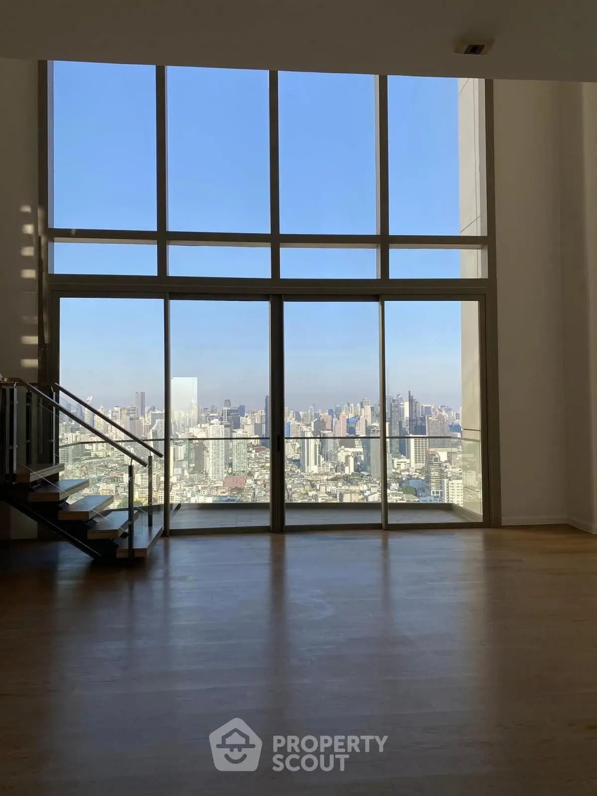 Stunning high-rise apartment with floor-to-ceiling windows and breathtaking city view.