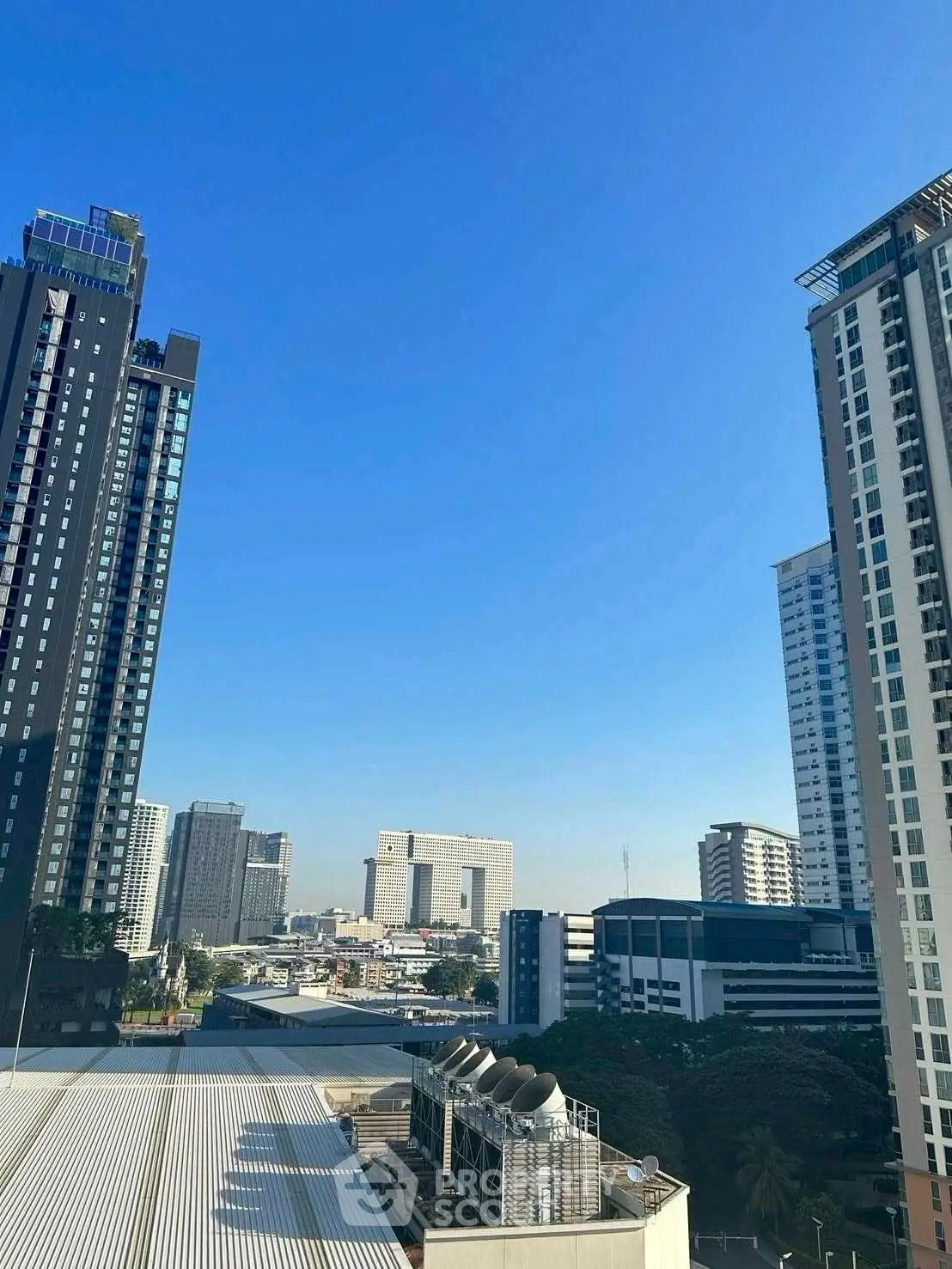 Stunning cityscape view with modern high-rise buildings under clear blue sky.