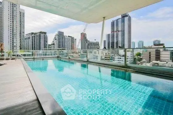 Stunning rooftop pool with city skyline views in modern urban setting.