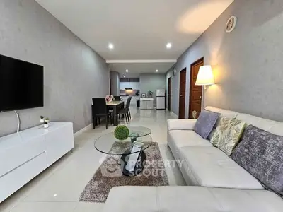 Modern living room with sleek furniture and open kitchen layout, perfect for stylish urban living.