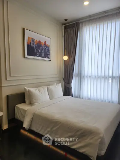 Elegant bedroom with modern decor and large window for natural light