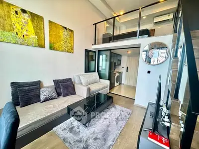 Modern loft-style living room with mezzanine, stylish decor, and open layout in a contemporary apartment.