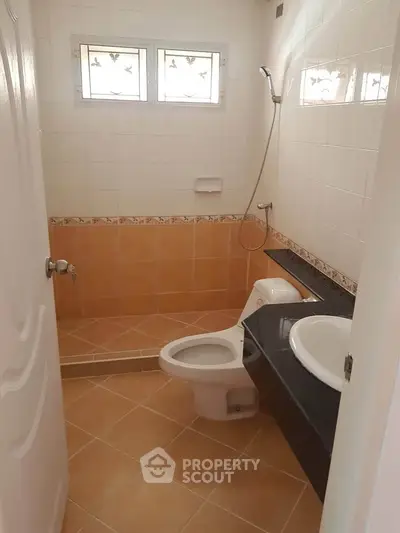 Cozy bathroom with modern fixtures and tiled flooring