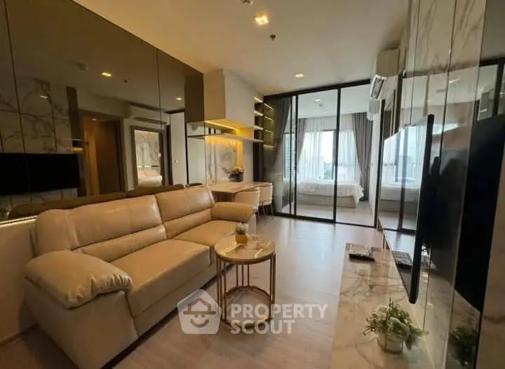 Modern living room with elegant decor and open view to bedroom
