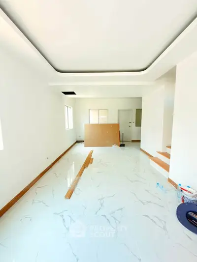 Spacious modern living room with glossy marble flooring and recessed ceiling design.