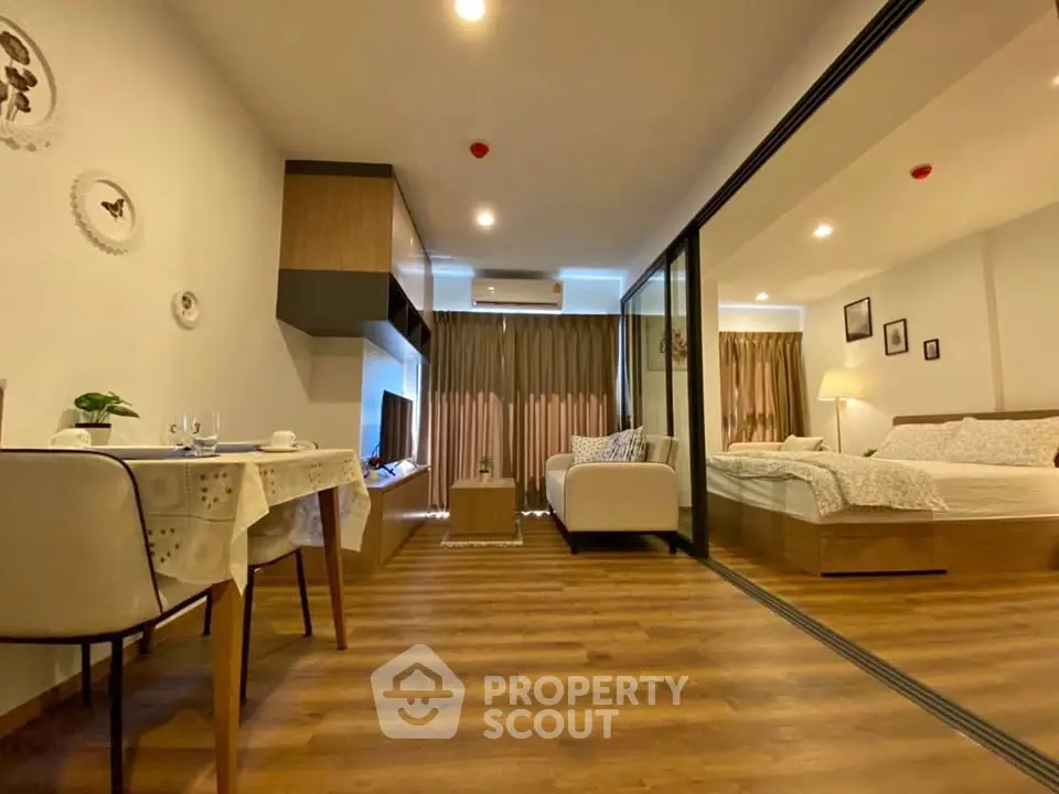 Modern studio apartment with open layout and stylish decor, featuring a cozy living area and elegant bedroom.