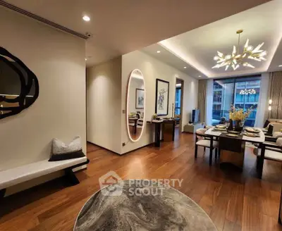 Luxurious open-plan living and dining area with elegant decor and modern lighting